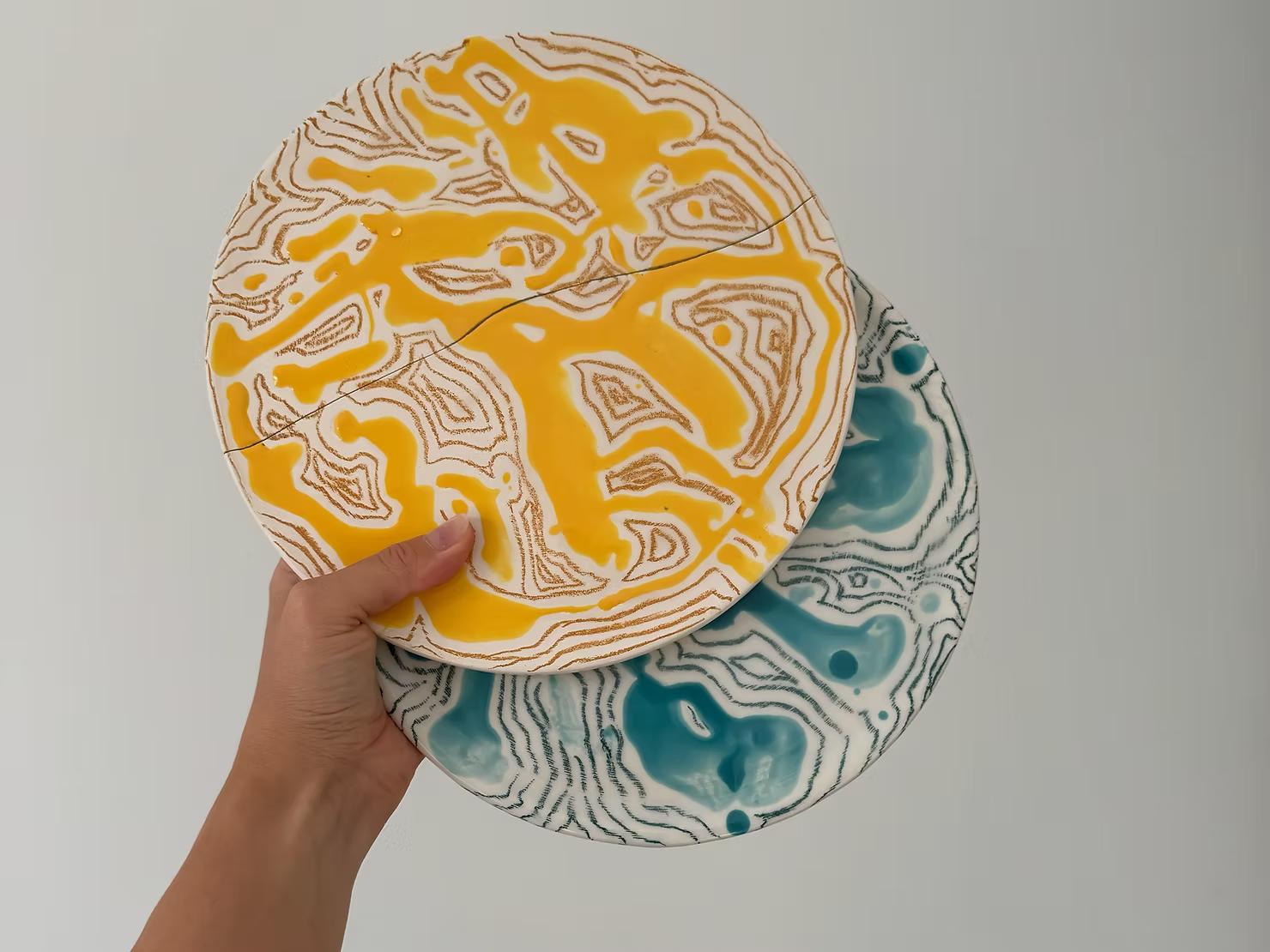 Broken ceramic plate with colorful stripes, ready for Kintsugi repair